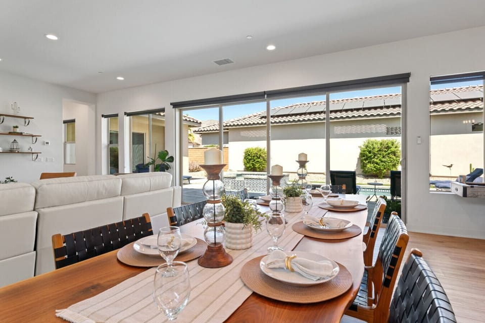 Bright living space w/ modern seating, high ceilings & sliding doors to the patio