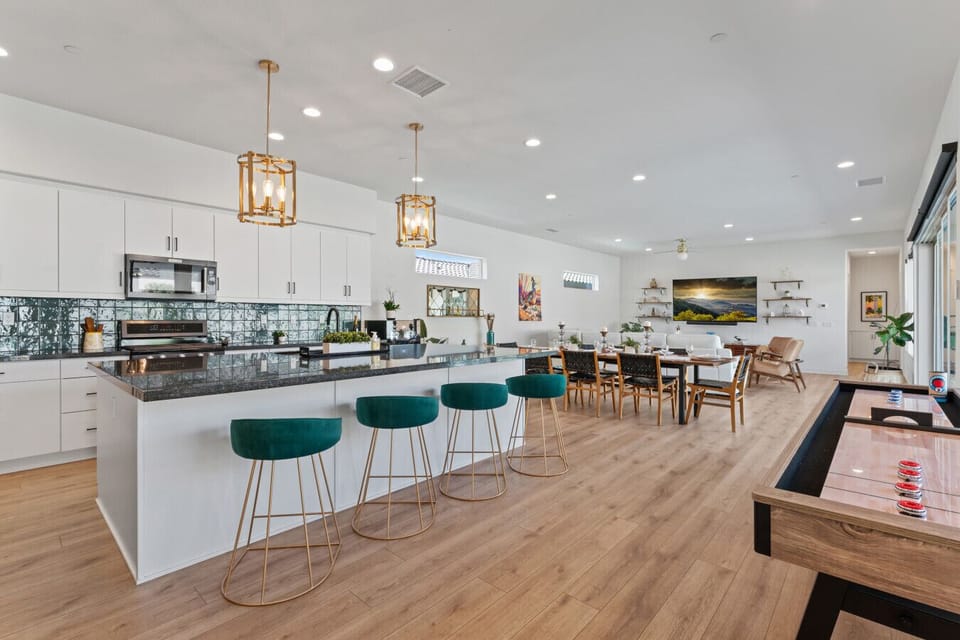 Modern kitchen & dining area w/ large island, bar stools & open layout for gatherings