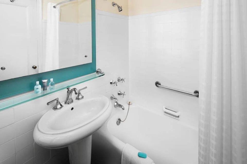 Soak and reset with a deep tub and bright vanity.