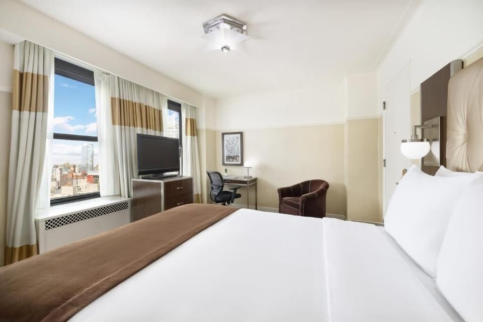 Wake up to city views and morning light by the windows.