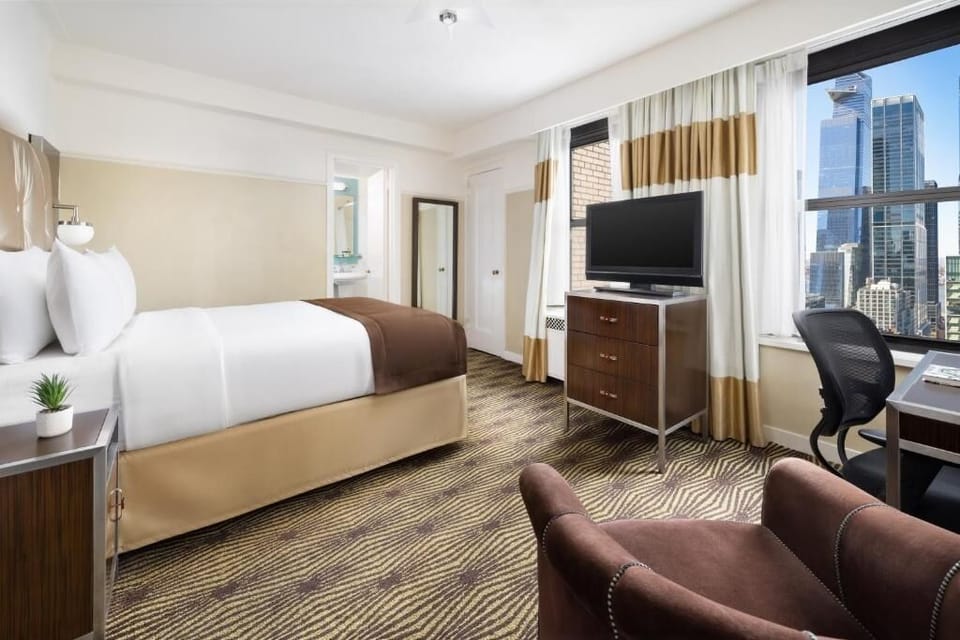 Relax in a spacious room with desk and lounge chair.