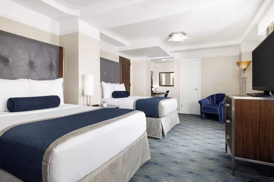Unwind in plush beds with crisp linens and calm lighting