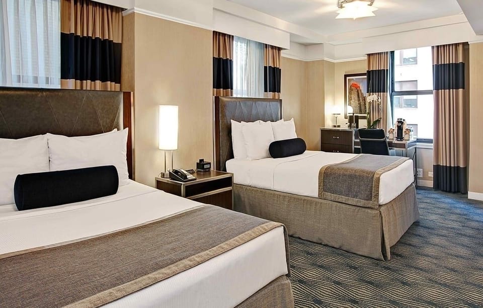 Unwind in crisp twin beds with warm, modern lighting.