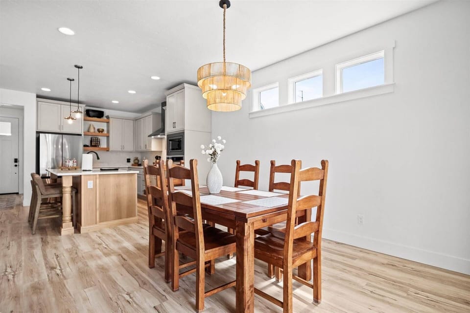 Spacious dining table seats 6, plus 3 additional seats at kitchen island