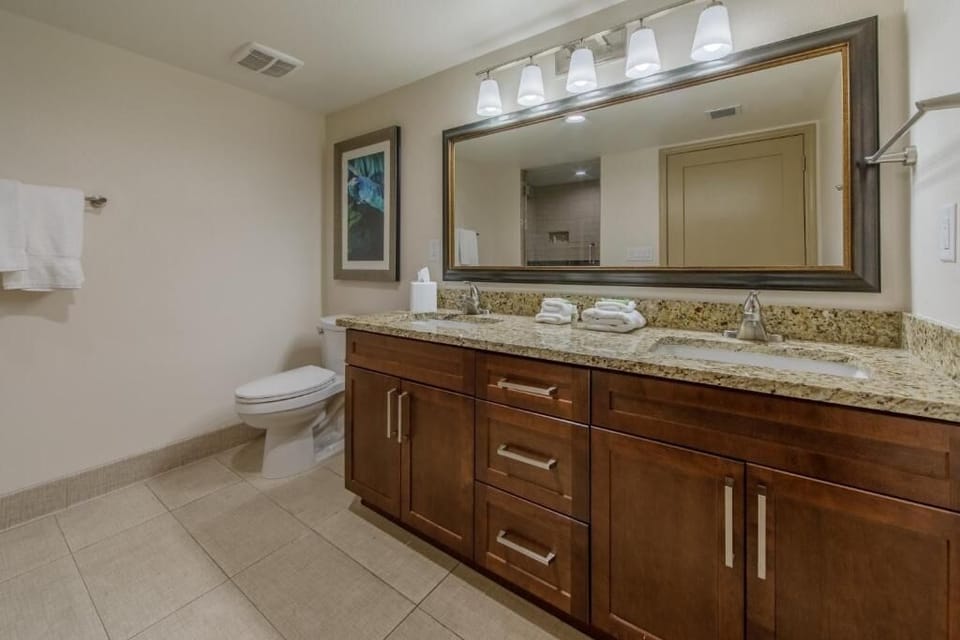 Start your day at a spacious vanity with bright lighting.