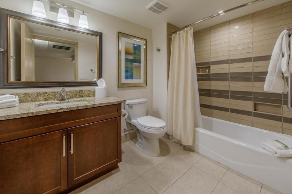 Rinse off in the clean, tiled shower-tub combo.