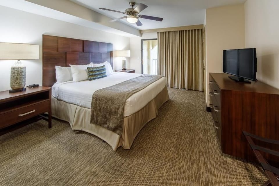 Unwind in a serene king bedroom with balcony breeze.