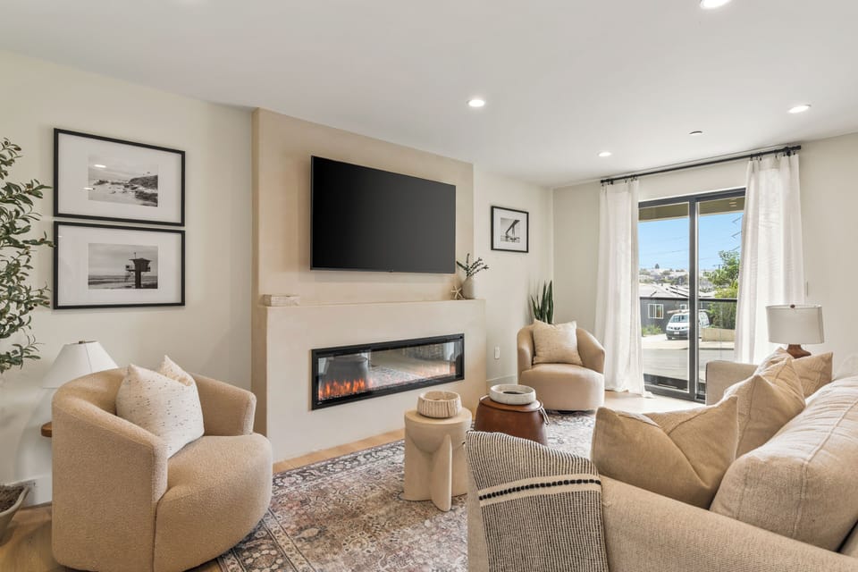 Living room with comfortable seating and a TV for relaxing nights in. (Point View Luxe)