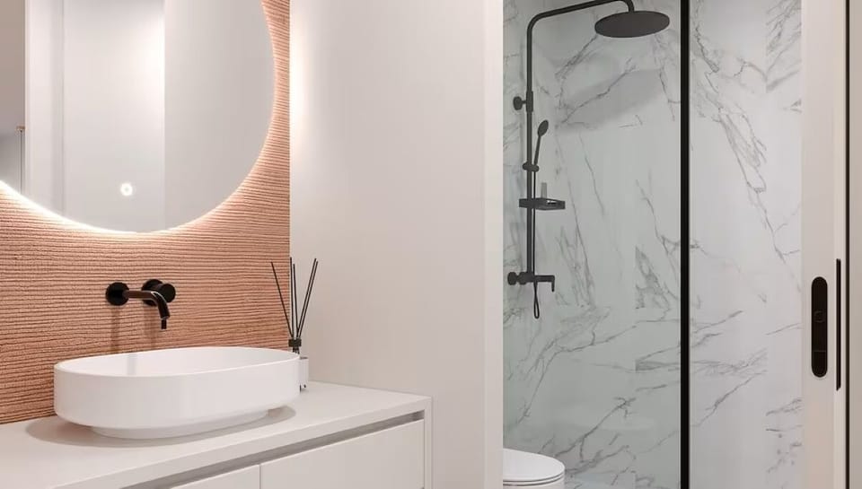 Start your day at a glowing mirror and designer vanity.