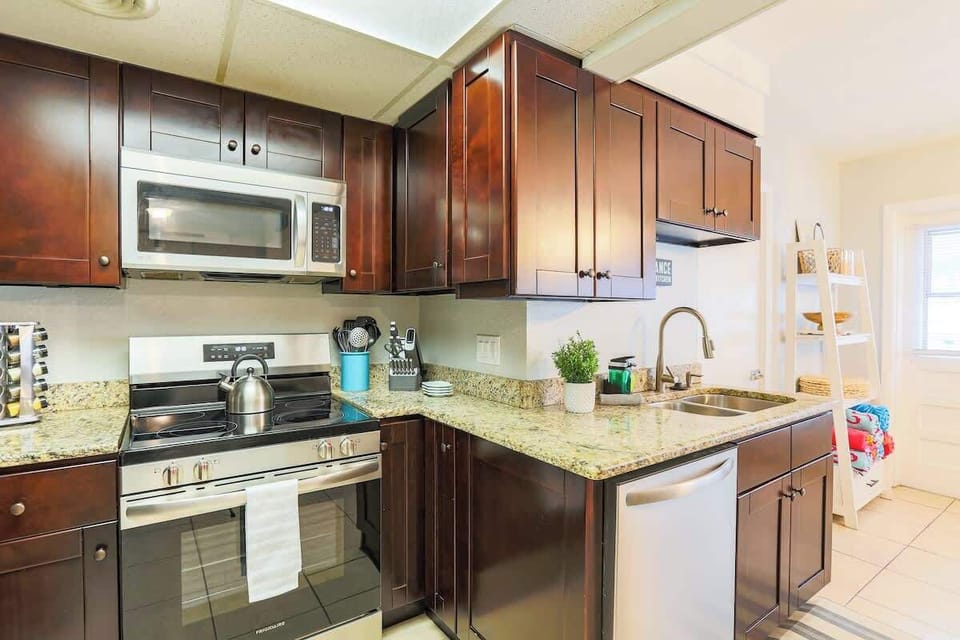 Located just off the main dining area, the kitchen offers easy flow for serving meals and gathering with friends and family, whether you're enjoying a quick snack or a full dinner.