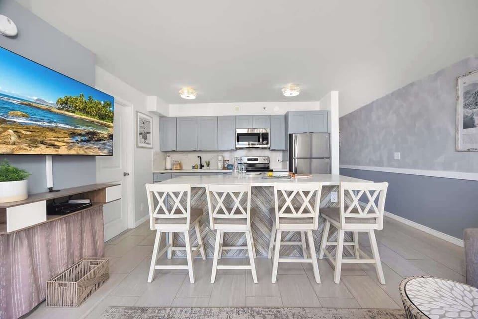 Modern and fully-equipped kitchen with a spacious island and bar seating, perfect for cooking and entertaining.