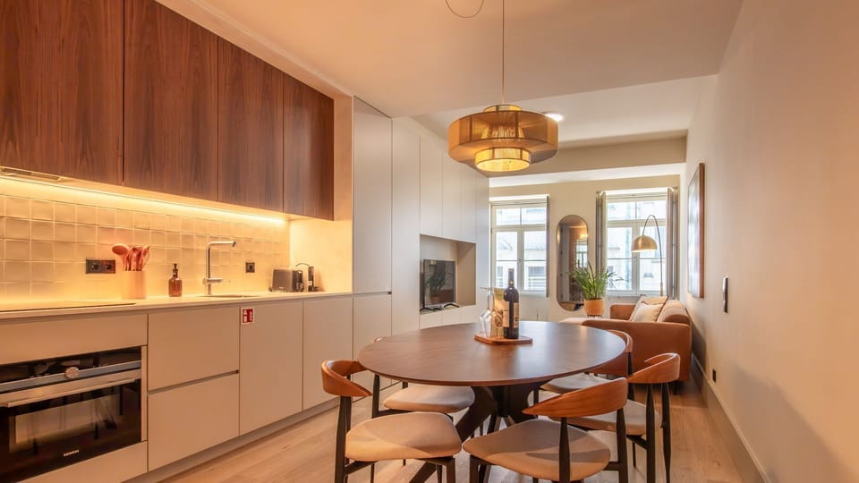Gather around a designer table in this open-concept space with moody lighting and curated finishes.