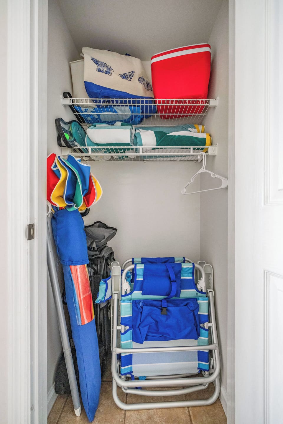 All you need for the beach: chairs, towels, cooler, umbrella, bag, and wagon.