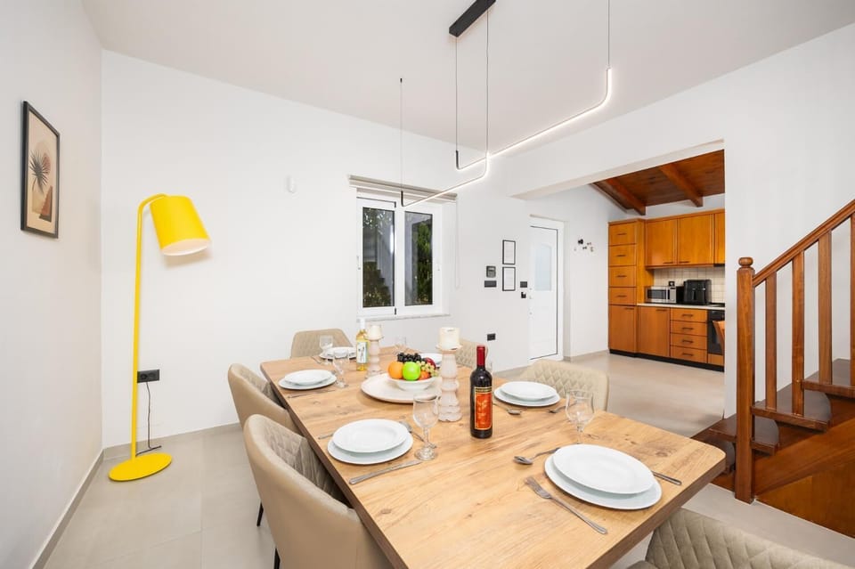 Living room with sofa, dining area, A/C, WiFi internet, and satellite TV