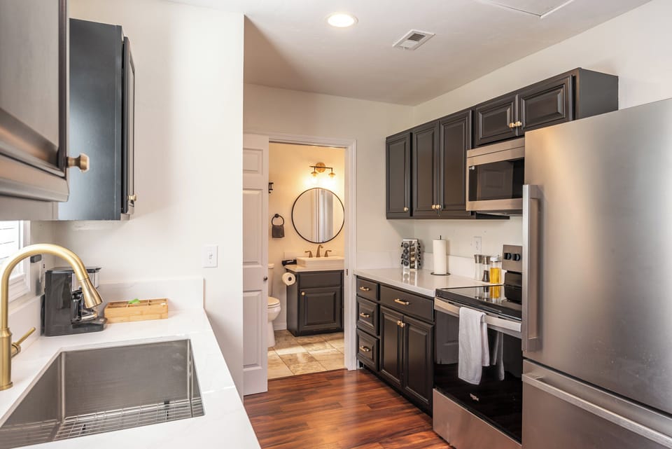 Kitchen - Full kitchen features a coffee maker, basic cooking essentials