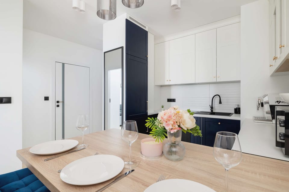 Fashionably furnished kitchenette with kitchen appliances and dining area.