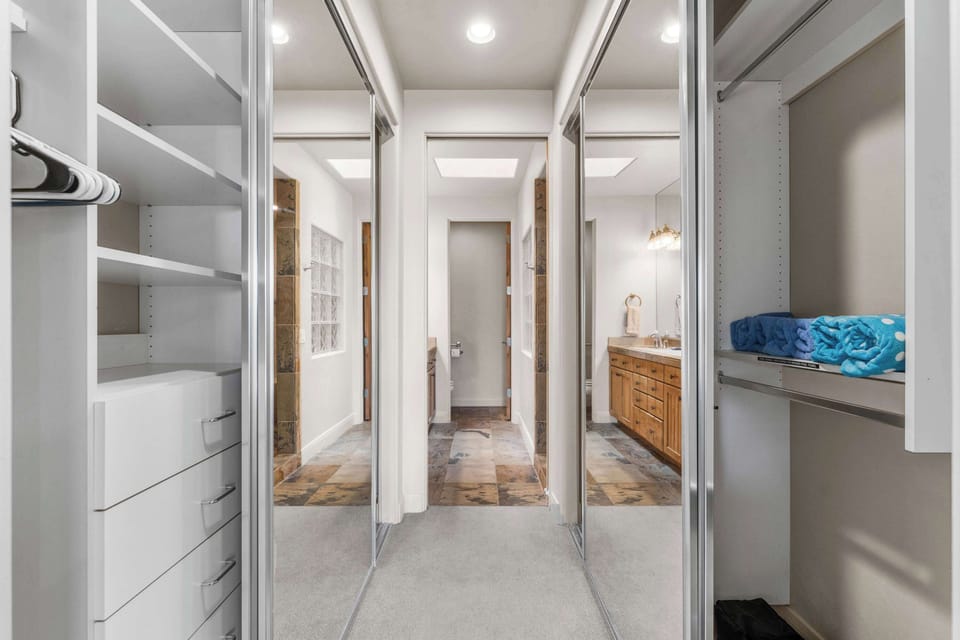 The serene primary king suite boasts a smart TV, ensuite bath, & patio access​