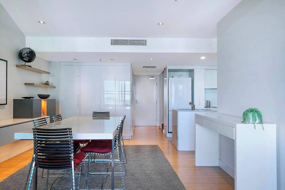 Enjoy meals together at home with a central dining table seating six.