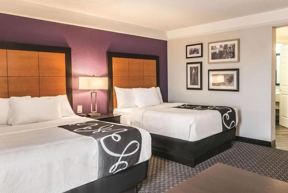 Unwind in crisp linens with cozy bedside lighting.
