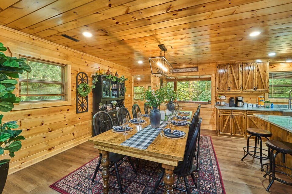 Rustic Cabin Dining Area | Long Wooden Table with Black Chairs and Cozy Open-Concept Layout