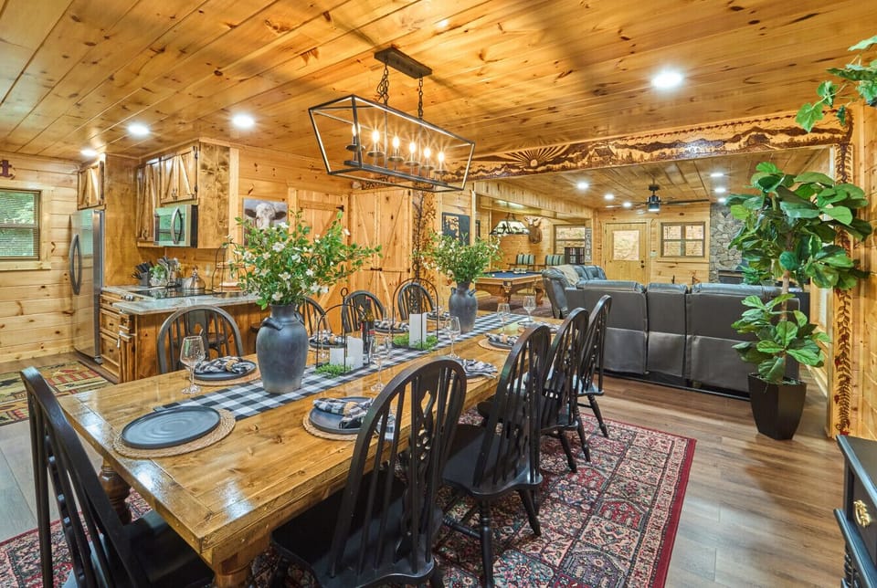Rustic Cabin Dining Area | Long Wooden Table with Black Chairs and Cozy Open-Concept Layout