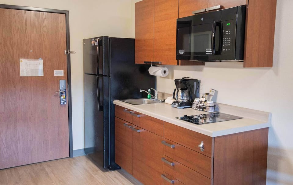 Cook simple meals with full-size fridge, microwave, and cooktop.