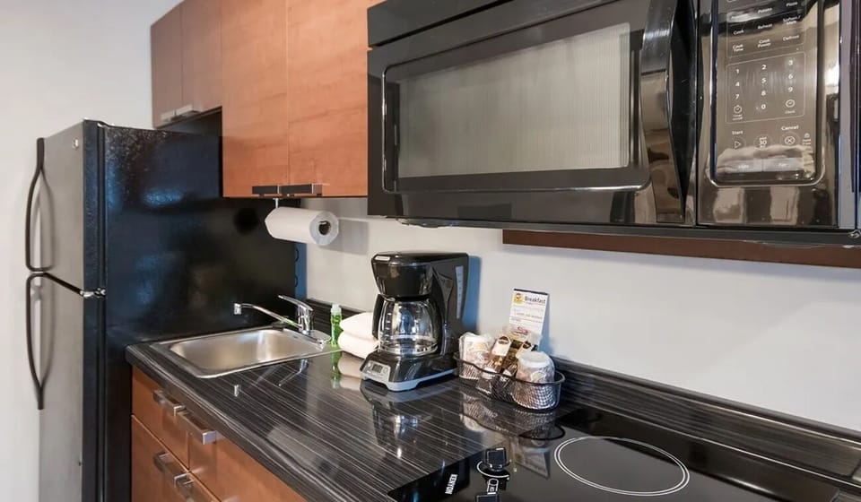 Brew morning coffee and prep snacks on sleek counters.