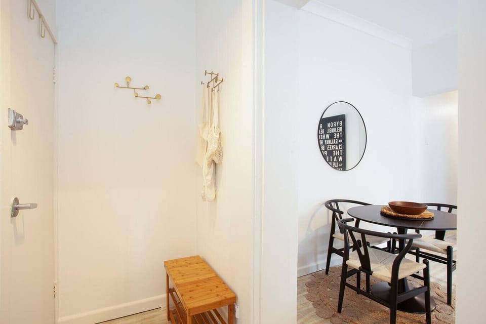 Entryway Charm: Bright space with a stylish bench and a chic dining nook for memorable meals!