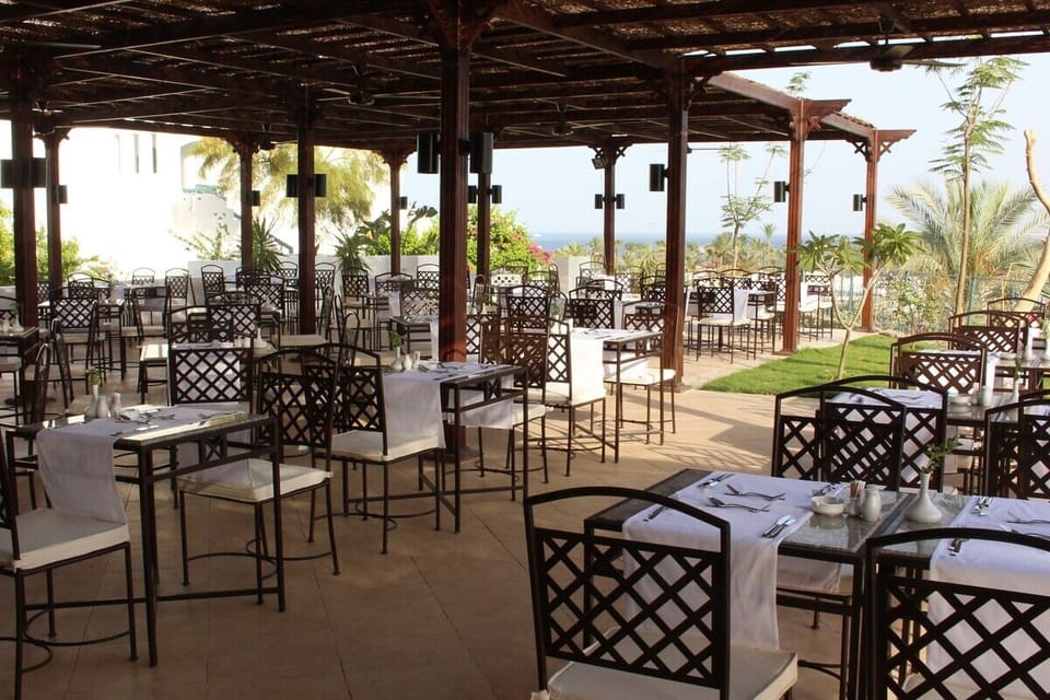 Savor open-air dining under shade with garden-and-sea breezes.