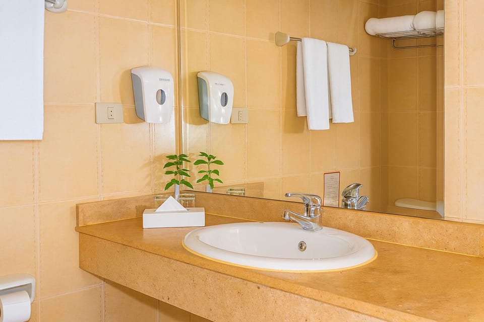 Refresh comfortably at the spacious vanity with bright lighting.