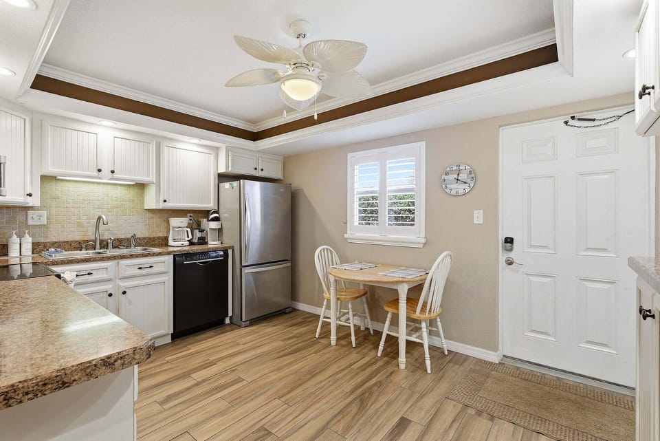 Charming kitchen with modern appliances, ample counter space, and a cozy dining nook. Ideal for your beach stay, enjoy easy meals and morning coffee before heading out for a relaxing day by the ocean.