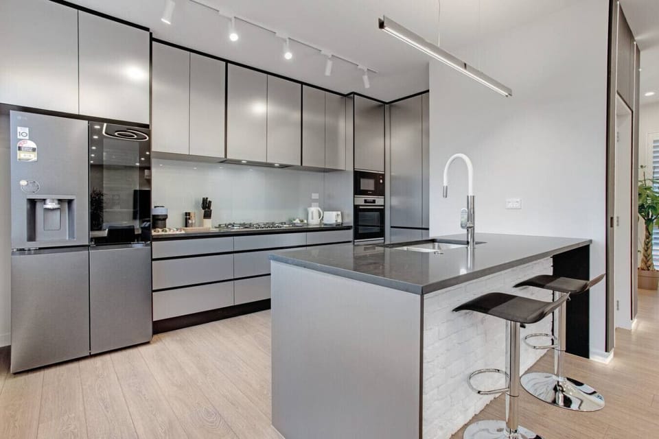 The kitchen has a gas cooktop, oven, microwave, fridge/freezer and dishwasher.