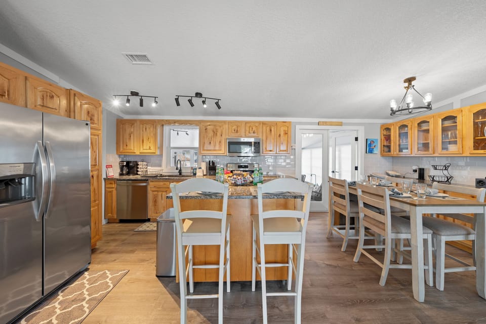 Fully equipped kitchen with stainless steel appliances,and two dining areas