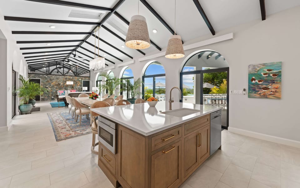 Open-concept living area flowing directly from the chef’s kitchen into dining an