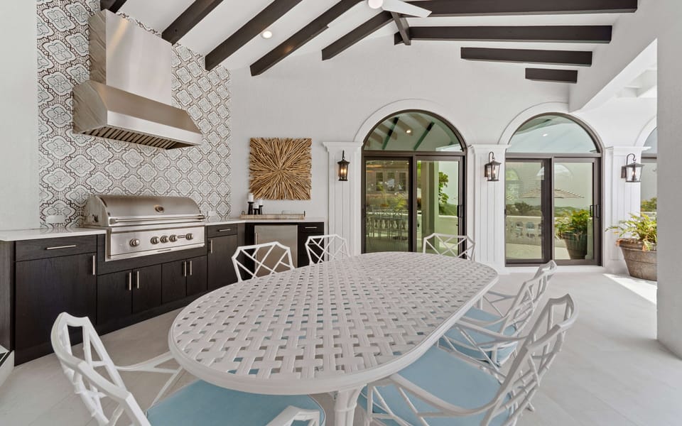 Covered outdoor dining area with grill