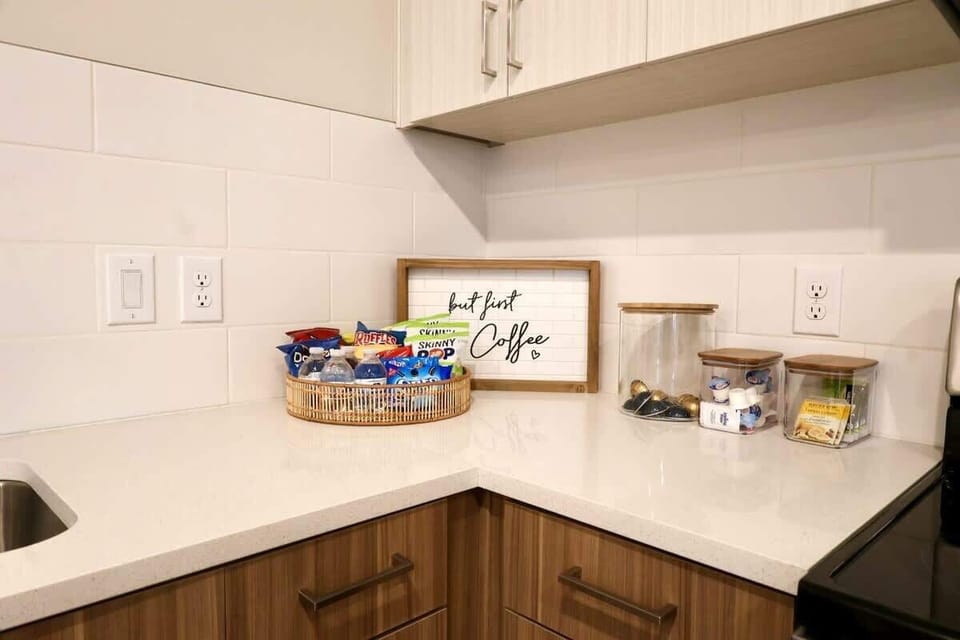- Coffee station stocked with snacks and essentials  
- Perfect for quick breakfasts or late-night cravings  
- Clean corner setup adds comfort to your stay  
