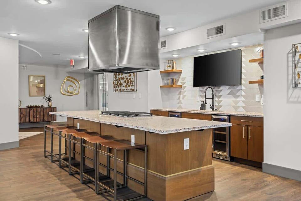 - Cook and gather in this stylish chef-inspired community kitchen  
- Spacious island seating makes every meal feel social and fun  
- Perfect for long stays with modern appliances and smart layout  