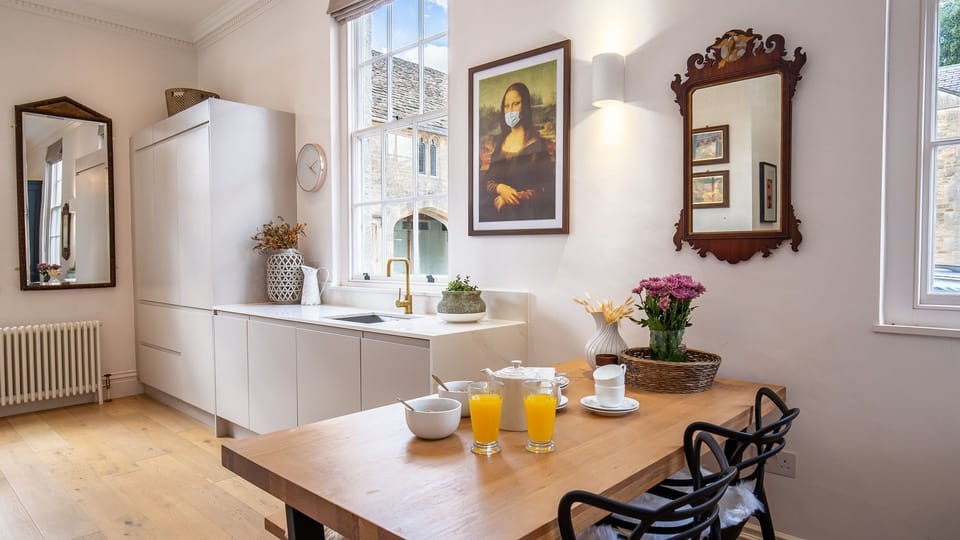The dining area is tucked beside the kitchen units with a bench and chairs to seat four.