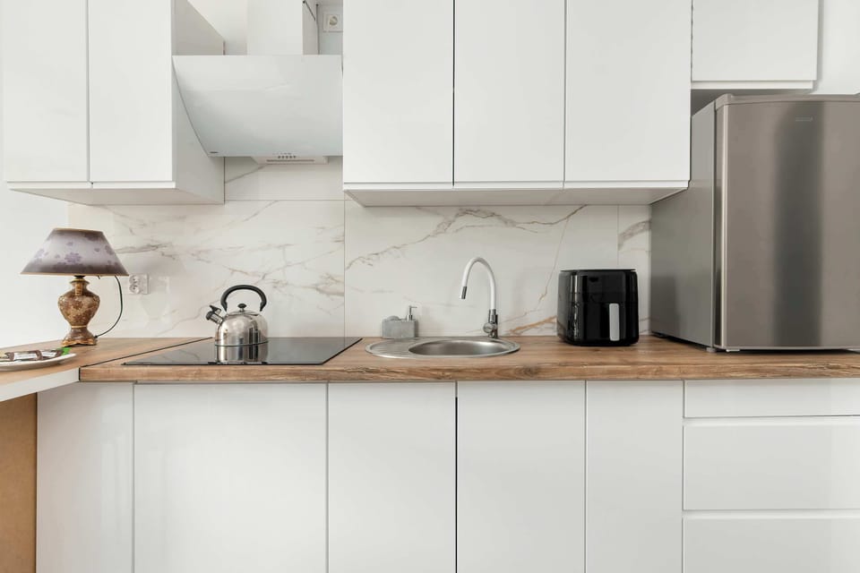 Modern kitchen with white cabinets,