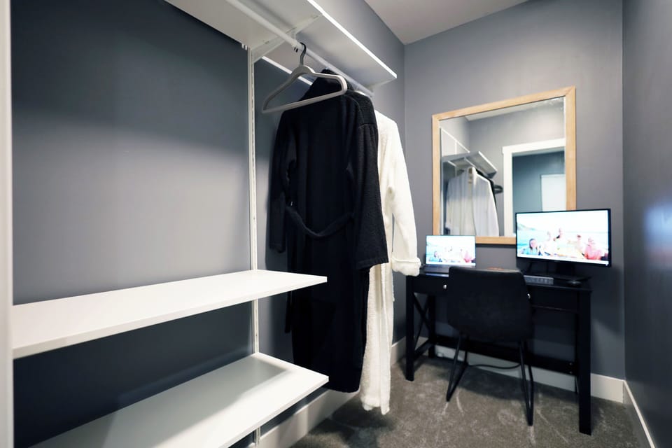 Master bedroom featuring closet workspace, balcony, and large en suite bath.