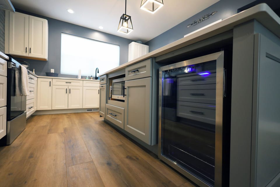 Beverage fridge and microwave located within the 8 foot island.