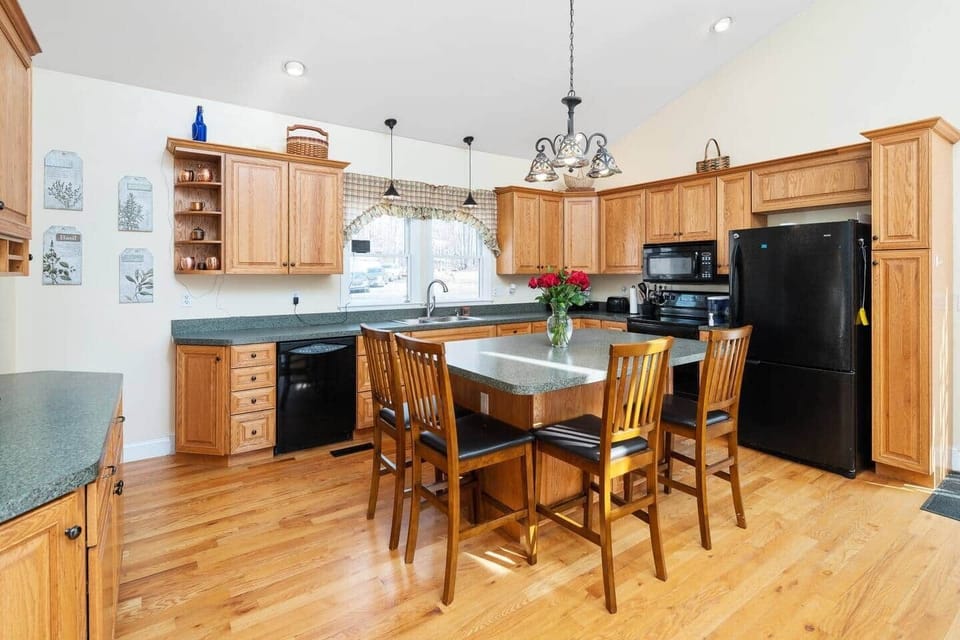 Open concept kitchen with bar and seating for four