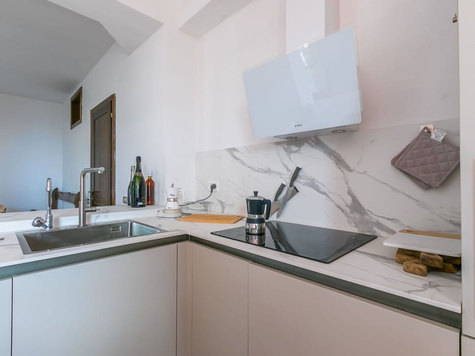 Countertop, Kitchen, Interior Design, Kitchen Appliance, Flooring, Furniture, Cabinetry, Room, Lighting, Home Appliance