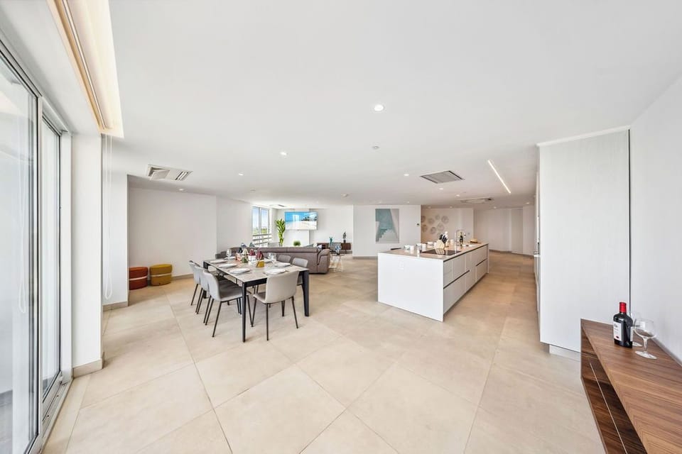 Picture yourself gathering with loved ones in this stunning open-concept space, where sleek modern design meets inviting warmth. Natural light floods your stylish kitchen and dining area, perfect for memorable meals.