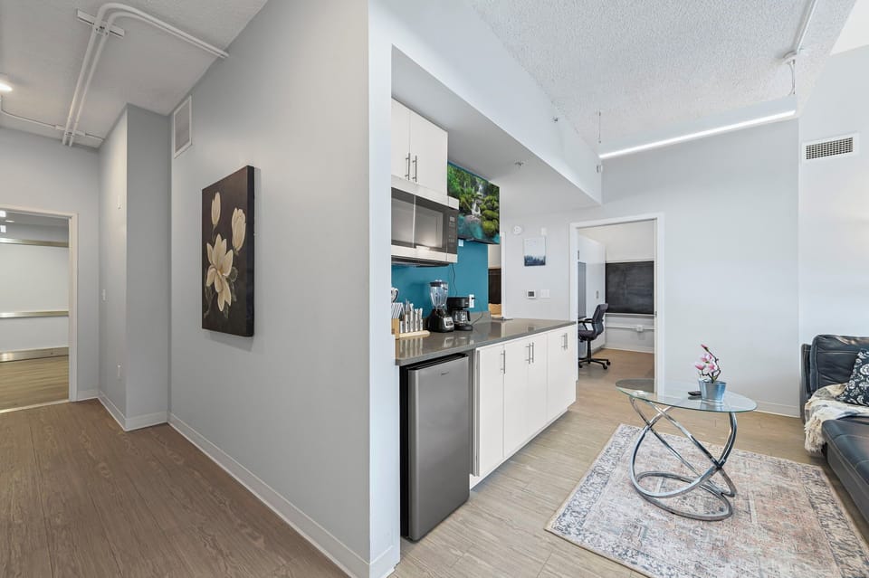 The hallway leads to private bedrooms, while the living area offers cozy seating