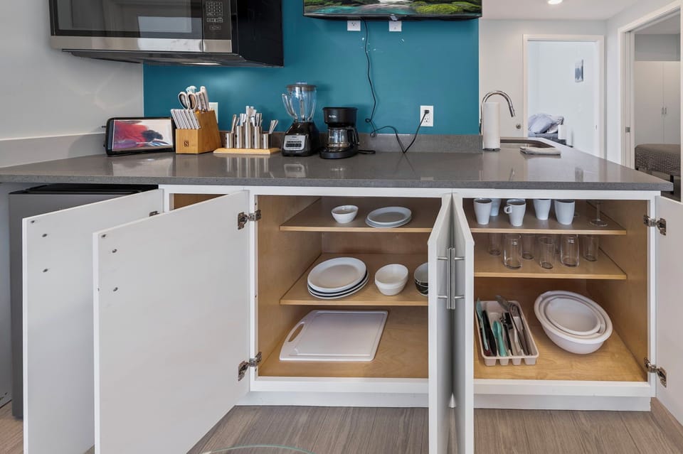 Fully stocked kitchenette w/ dishes, microwave, coffee maker & cookware.