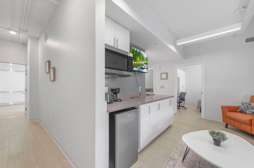 Modern unit w/ kitchenette, smart TV & lounge—great for dining or relaxing.
