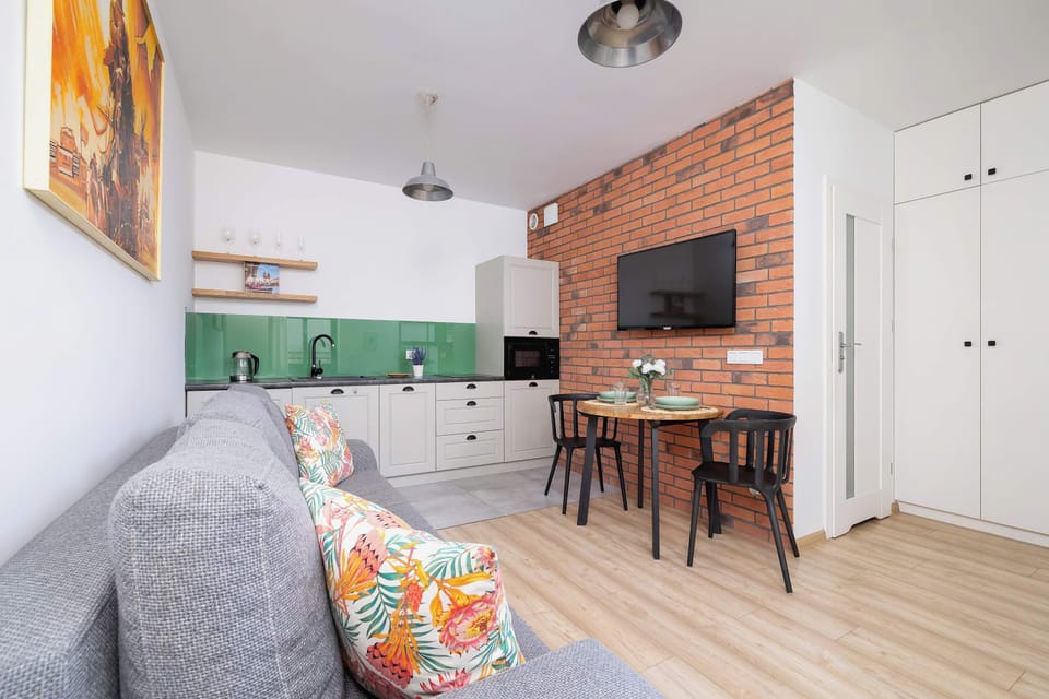 A spacious dining area with a large table, comfortable chairs, and bright walls decorated with artwork encourages shared meals and conversations.