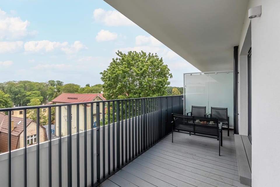 Balcony with garden furniture and view of the surroundings.