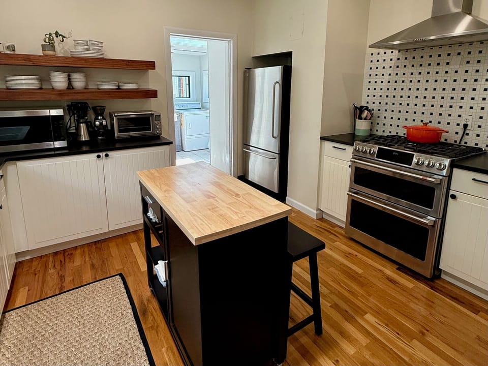 Fully stocked kitchen with GE appliances and adjacent walk-in pantry
